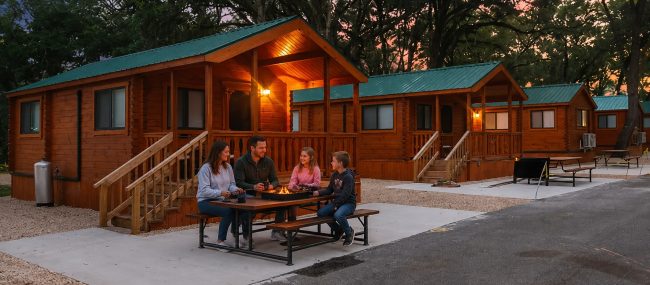 Family enjoying a glamping cabin vacation at Stony Fork Creek Campground in Pennsylvania