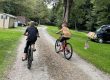 Children riding bicycles through Stony Fork Creek Campground during a summer family camping vacation