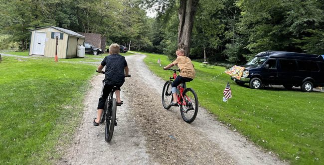 Summer Family Camping at Stony Fork Creek Campground Children riding bicycles through Stony Fork Creek Campground during a summer family camping vacation
